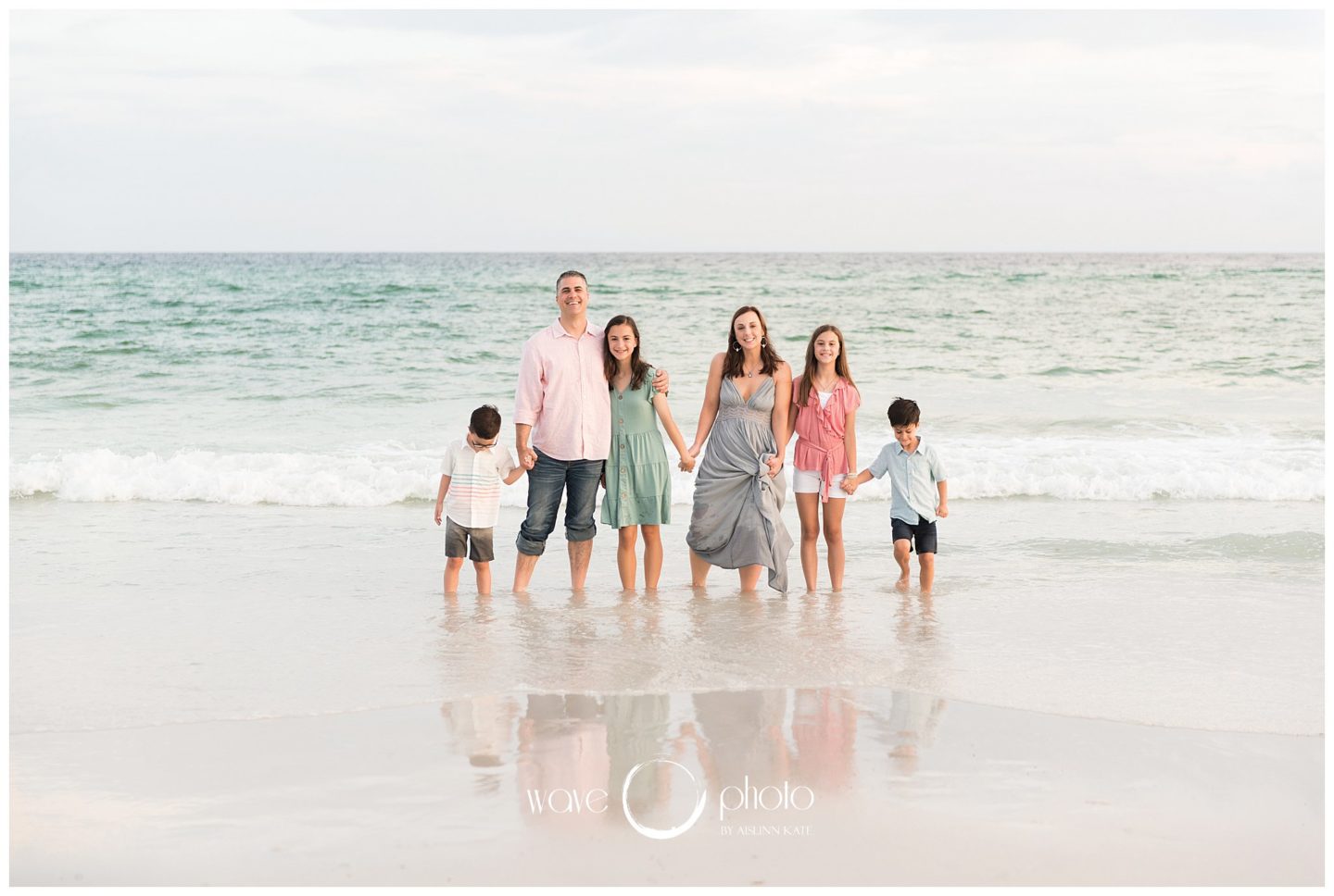 family-smiling-and-holding-hands-on-beach-destin-florida