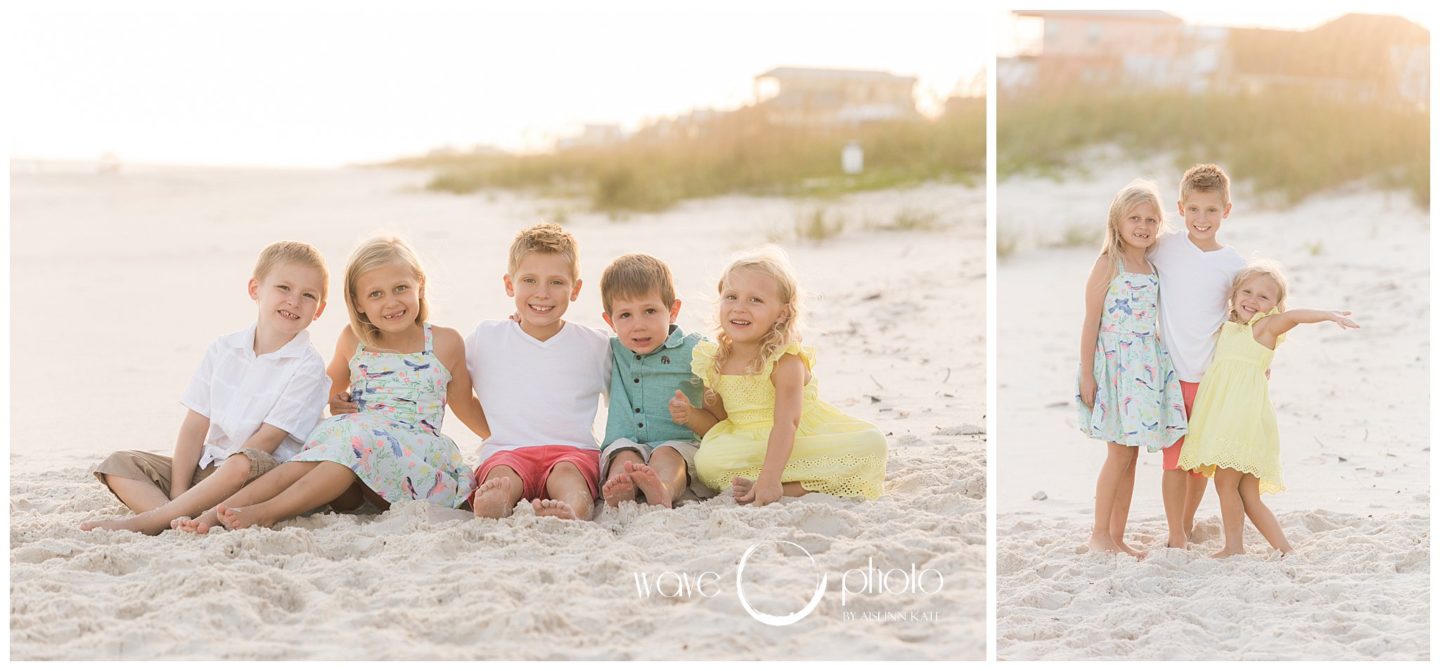 kids-smiling-sitting-on-the-beach-orange-beach-gulf-shores-beach-florida
