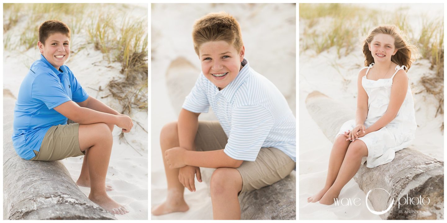 siblings-sitting-on-log-on-beahc-pensacola-beach-florida