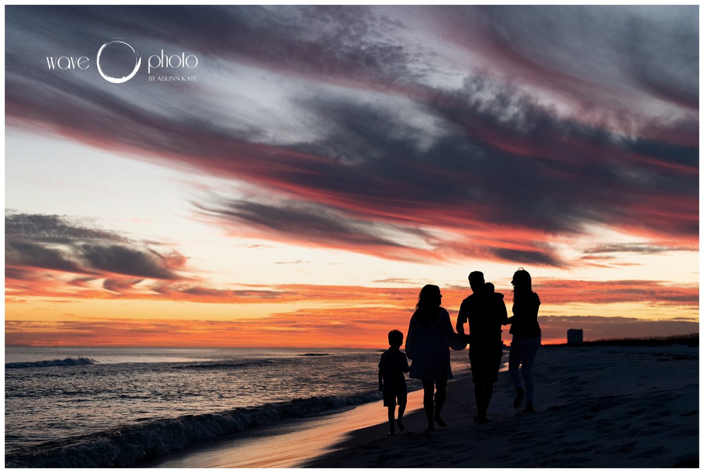 family-holding-hands-at-sunset-on-beach-pensacola-beach-florida