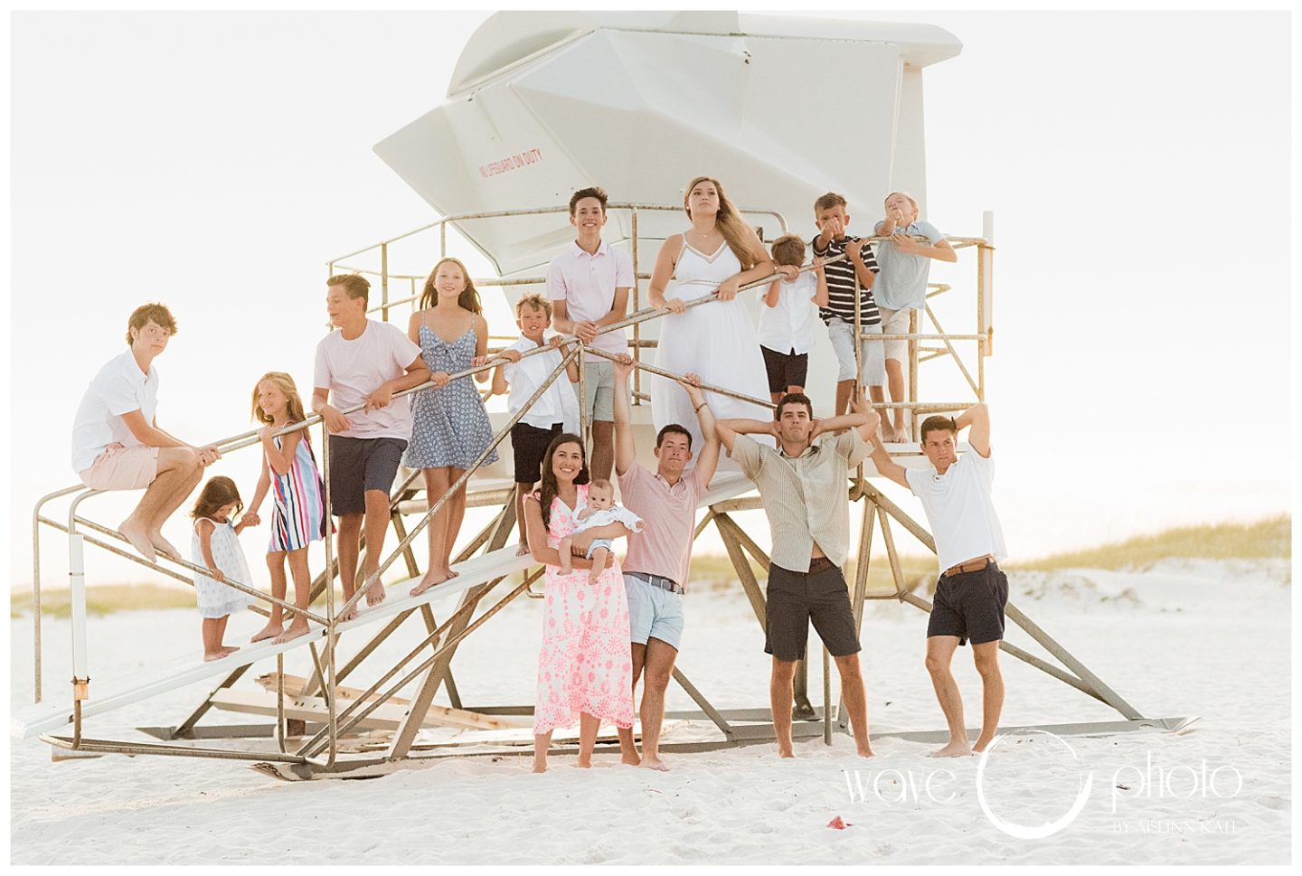 family-climbing-on-lifeguard-stand-smiling-pensacola-beach-florida